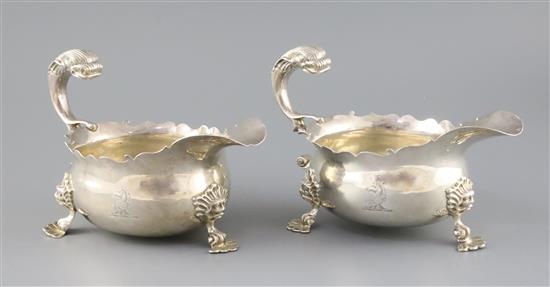 A pair of Victorian silver sauceboats with flying scroll dolphin head handles, London, 1883, 30.5oz.